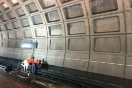Workers installed track bed lighting in the Courthouse station in Arlington, Va. (WTOP/Megan Cloherty)