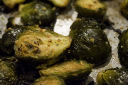 oven pan roasted brussel sprouts in olive oil, salt, sweet red peppers, spices and garlic shot in kitchen studio