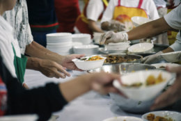 Volunteers Share Food to the Poor to Relieve Hunger: Charity concept (Getty Images/iStockphoto/kuarmungadd)