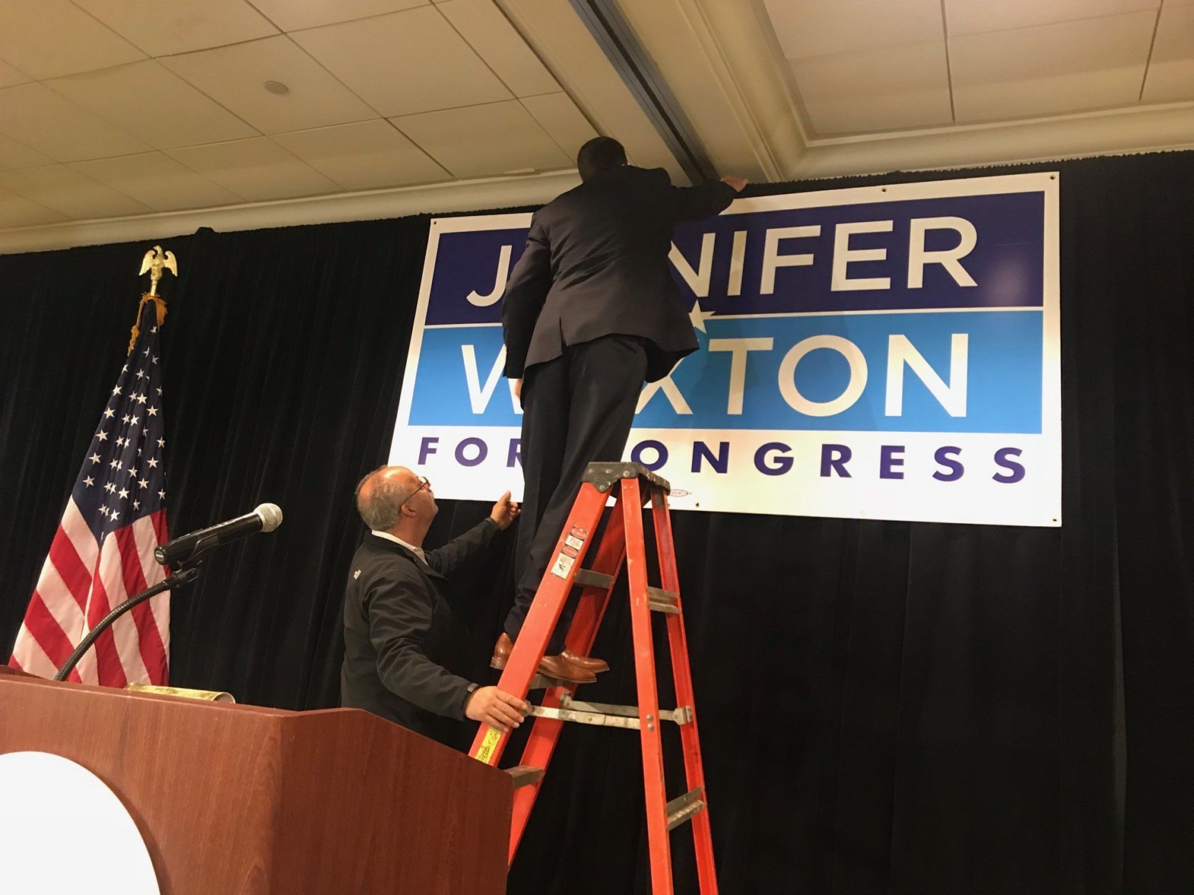 Workers put the finishing touches on what they hoped would be Jennifer Wexton's victory celebration Tuesday. (WTOP/Dick Uliano)