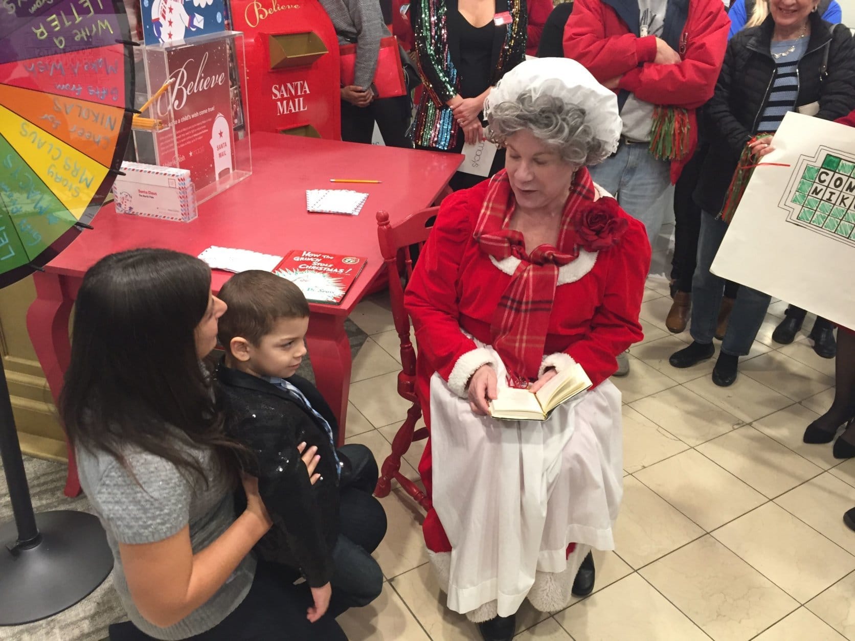 Mrs. Claus was on hand to read “The Night Before Christmas” to Nikolas. (WTOP/John Domen)