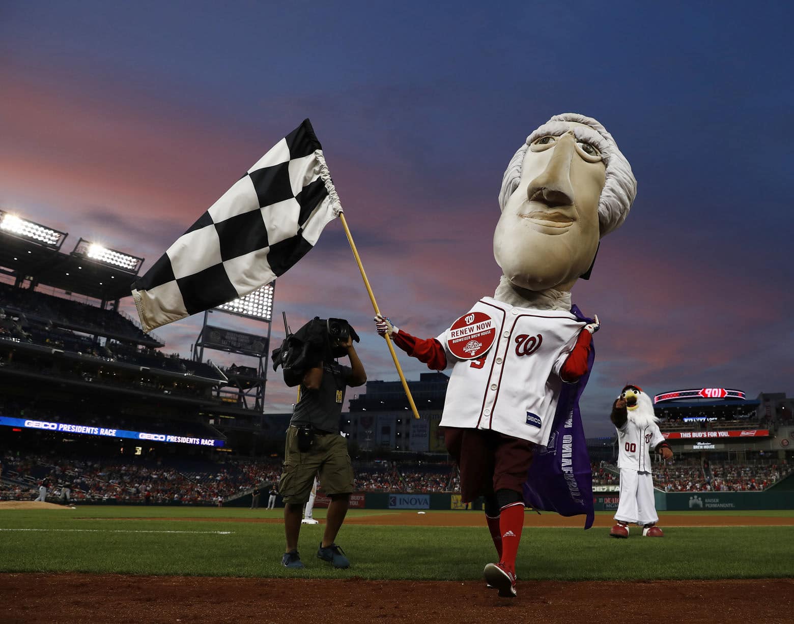 Washington Nationals racing presidents mascot Thomas Jefferson wins the race during the fourth inning of a baseball game between the Nationals and the Miami Marlins, Thursday, Aug. 10, 2017, in Washington. The Nationals won 3-2. (AP Photo/Carolyn Kaster)
