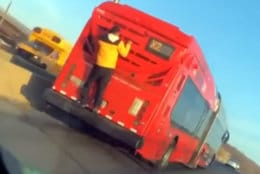 Viral video that lit up the web Tuesday purports to show a man clinging to the back of an X2 Metrobus in D.C. (@RastaTahj via Twitter)