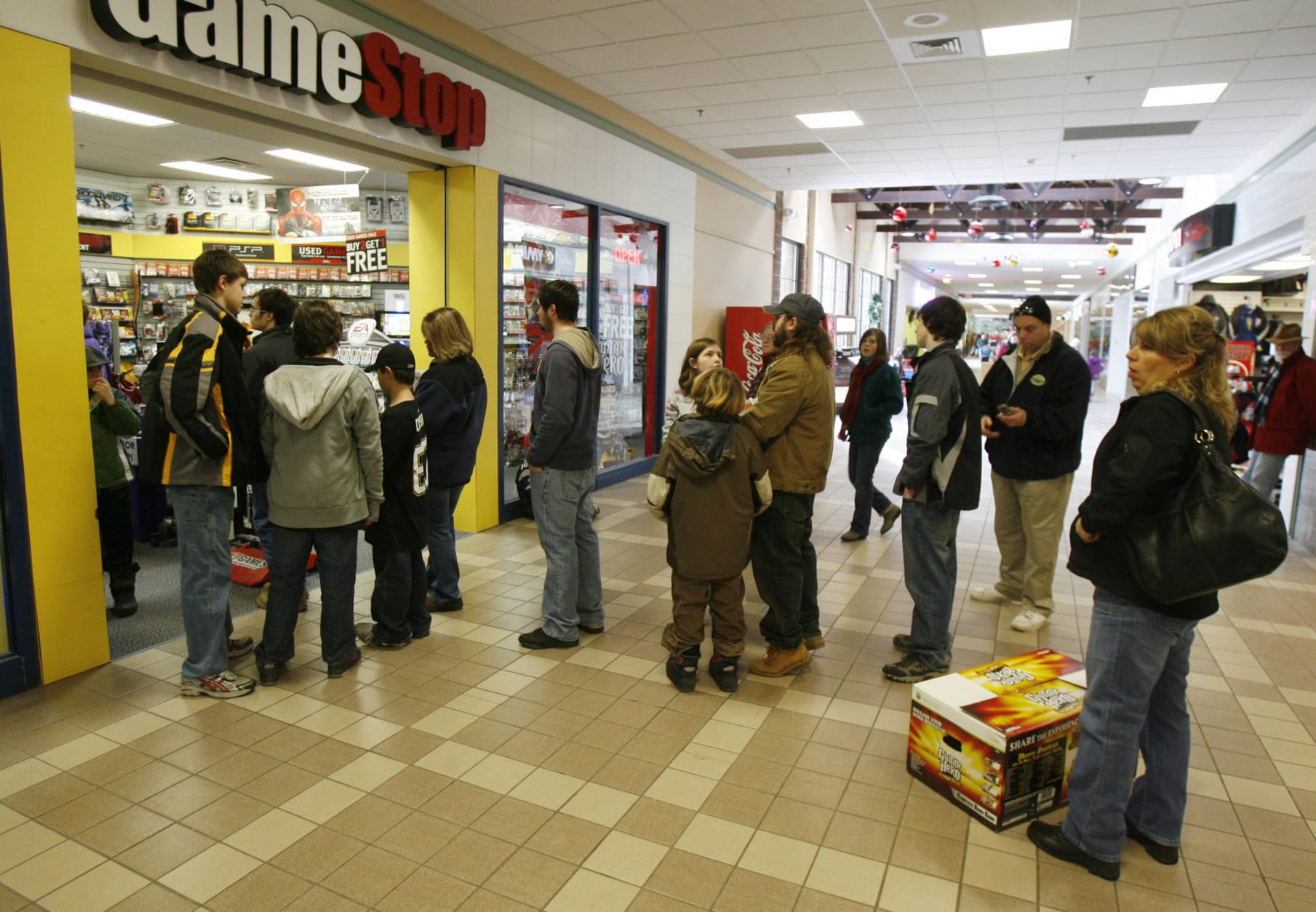 A line of shoppers extends out of the store into the mall hallway at the Game Stop store in Berlin, Vt., Friday, Dec. 26, 2008. Shoppers hit the stores early Friday to return unwanted gifts and take advantage of drastic price cuts offered by retailers desperate to get rid of old merchandise and boost their less-than-cheery holiday sales.(AP Photo/Toby Talbot)