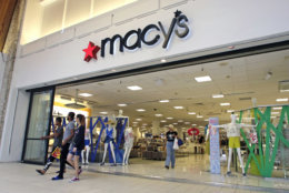 In this Wednesday, June 7, 2017, photo, people walk out of a Macy's department store in Hialeah, Fla. Macy’s is increasing the number of temporary workers it’s hiring for distribution and warehouses for the holiday season as it chases fast growing e-commerce sales. But overall holiday hiring will fall nearly 4 percent. (AP Photo/Alan Diaz)