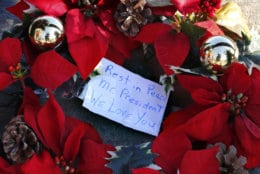 A wreath with a note to former President George H. W. Bush lay at a makeshift memorial across from Walker's Point, the Bush's summer home, Saturday, Dec. 1, 2018, in Kennebunkport, Maine. Bush died at the age of 94 on Friday, about eight months after the death of his wife, Barbara Bush. (AP Photo/Robert F. Bukaty)