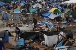Migrants walk amidst flooded tents after heavy rains poured down on a sports complex sheltering thousands of Central Americans in Tijuana, Mexico, on Nov. 29, 2018. Aid workers and humanitarian organizations expressed concerns about the unsanitary conditions at the severely overcrowded facility, where lice infestations and respiratory infections are rampant. (AP Photo/Rebecca Blackwell)