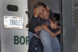 A father and his 3-year-old son are detained in the back of a U.S. Customs and Border Patrol vehicle on July 18, 2018, in San Luis, Ariz. The boy, his father and two siblings were arrested by a U.S. Border Patrol agent who spotted them crossing a canal along the the international border. (AP Photo/Matt York)