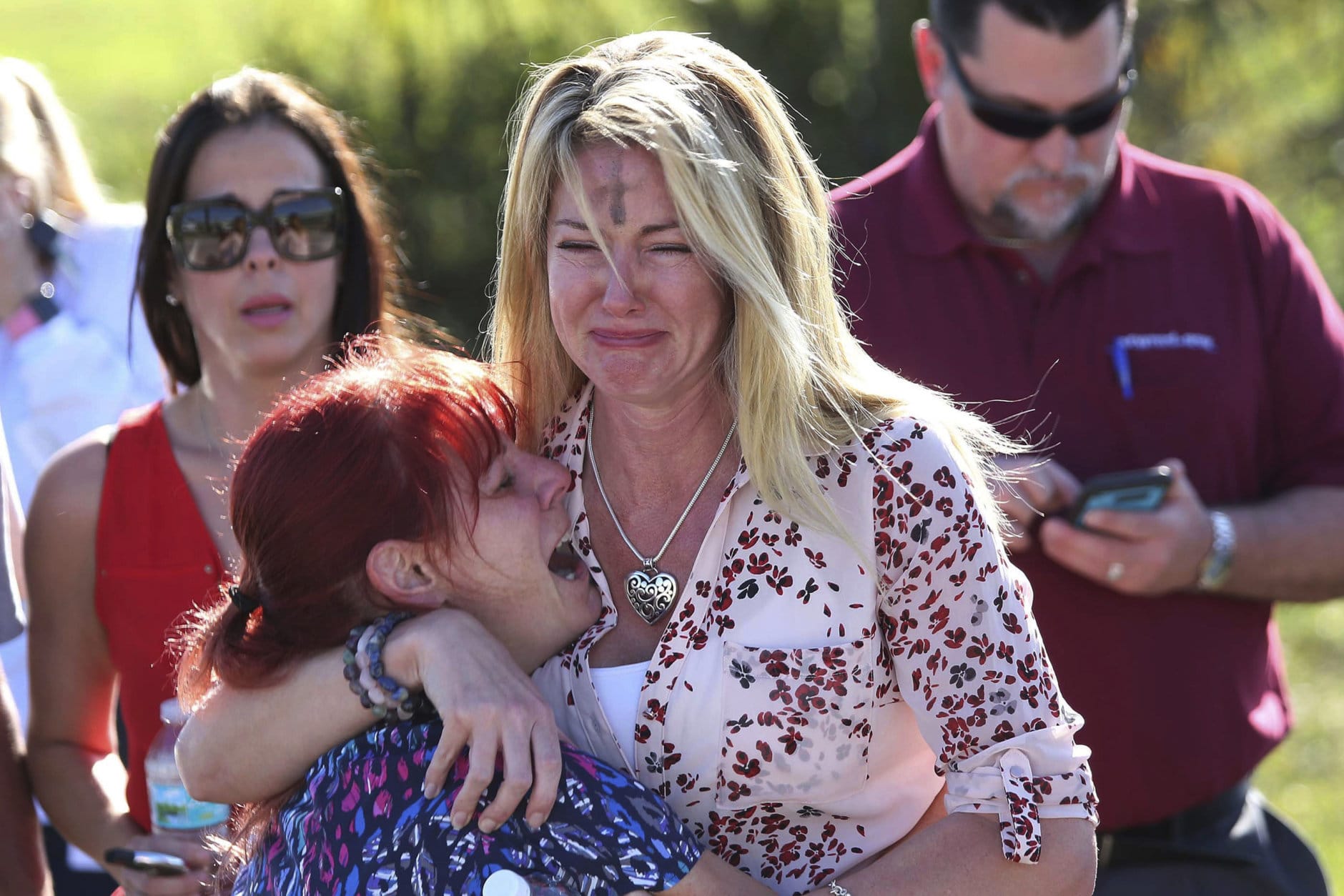 Parents wait for news of their loved ones after a mass shooting at Marjory Stoneman Douglas High School in Parkland, Fla., on Feb. 14, 2018. (AP Photo/Joel Auerbach)
