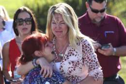 Parents wait for news of their loved ones after a mass shooting at Marjory Stoneman Douglas High School in Parkland, Fla., on Feb. 14, 2018. (AP Photo/Joel Auerbach)