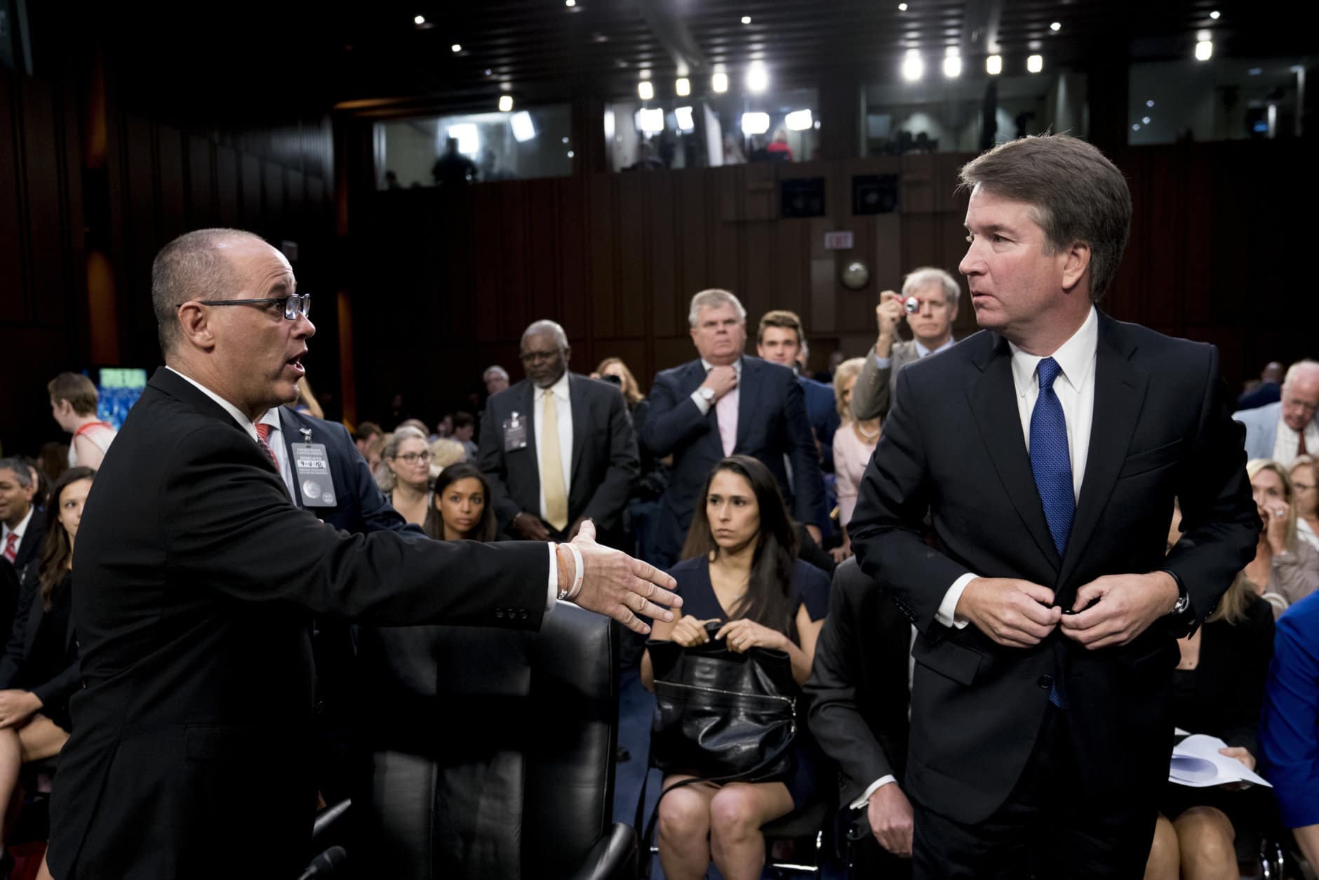 Fred Guttenberg, left, the father of Jamie Guttenberg, who was killed in the high school shooting in Parkland, Fla., attempts to shake hands with Brett Kavanaugh, President Donald Trump's Supreme Court nominee, as he leaves for a lunch break during his appearance before the Senate Judiciary Committee on Capitol Hill in Washington on Sept. 4, 2018. Kavanaugh did not shake his hand. (AP Photo/Andrew Harnik)