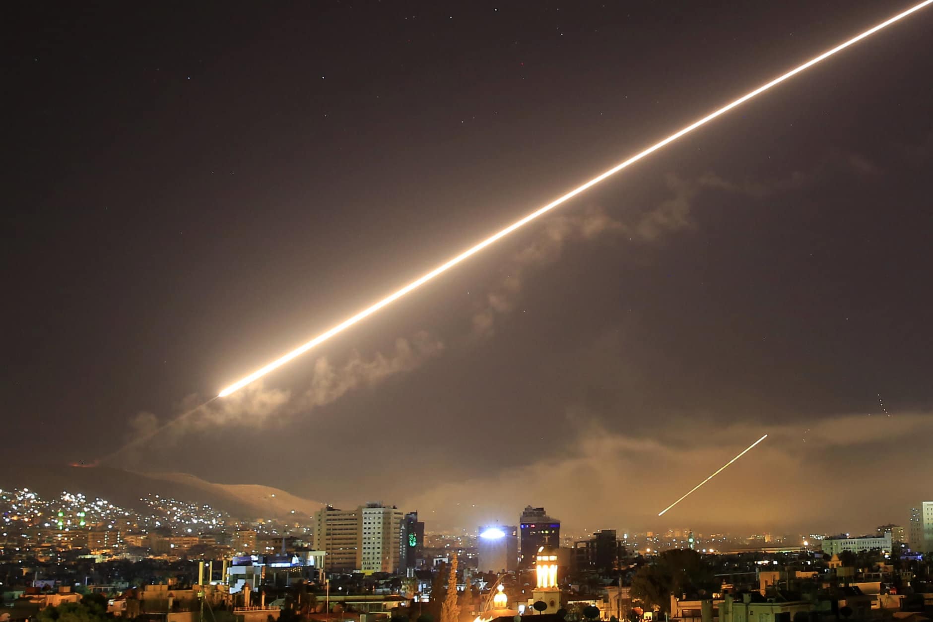 Surface to air missile fire lights up the sky over Damascus at the U.S. launches an attack on Syria early on April 14, 2018. U.S. President Donald Trump ordered the airstrikes in retaliation for Syria's alleged use of chemical weapons. (AP Photo/Hassan Ammar)