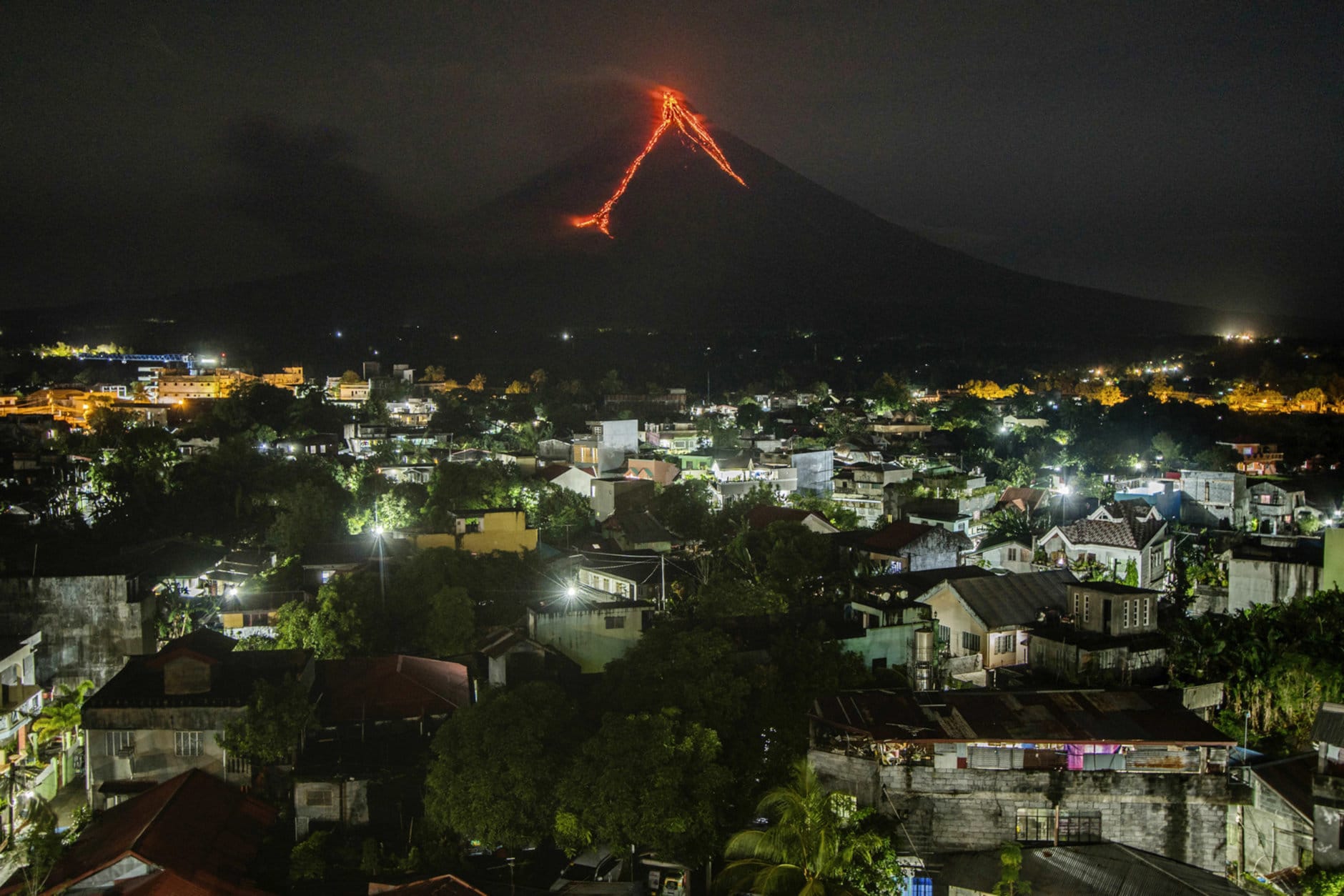 Lava flows down the slopes of the Mayon volcano in the Philippines, seen from Legazpi city, 340 kilometers (210 miles) southeast of Manila, on Jan. 16, 2018. (AP Photo/Dan Amaranto)