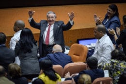 Outgoing President Raul Castro raises his arms in celebration after Miguel Diaz-Canel was elected as the island nation's new president, at the National Assembly in Havana, Cuba on April 19, 2018. Castro passed Cuba's presidency to Diaz-Canel, putting the island's government in the hands of someone outside the Castro family for the first time in nearly six decades. Raul Castro remains head of the powerful Communist Party that oversees political and social activities. (Adalberto Roque/Pool via AP)