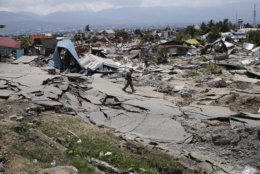 A man walks through the Balaroa neighborhood in Palu, Central Sulawesi, Indonesia, on Oct. 2, 2018, four days after a massive earthquake struck the region. (AP Photo/Dita Alangkara)