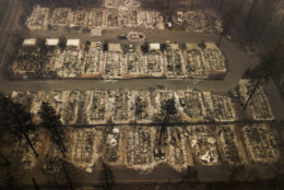 Ashes and debris are all that remain where houses once stood in Paradise, Calif., on Nov. 15, 2018, after a wildfire destroyed the town. (AP Photo/Noah Berger)