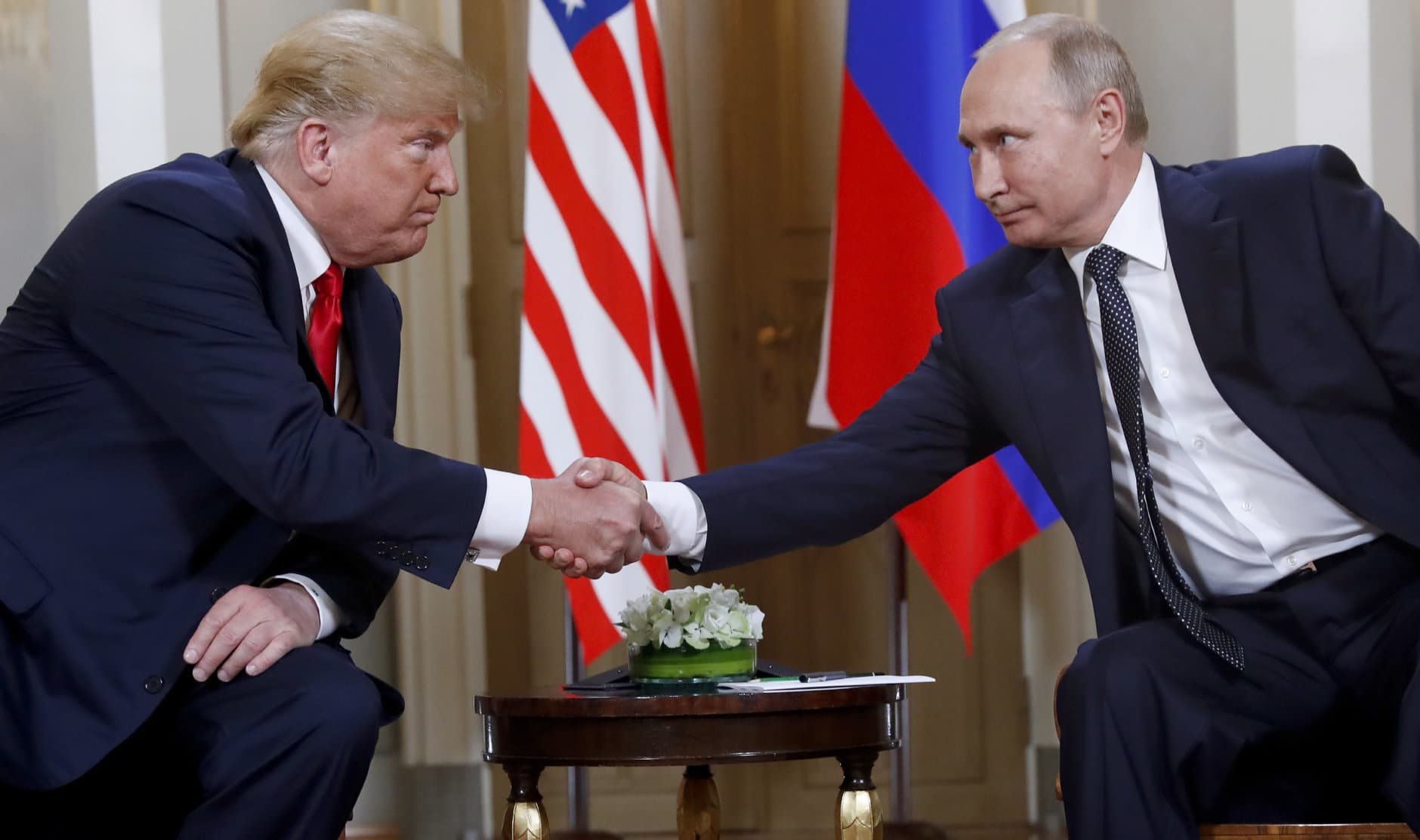 U.S. President Donald Trump, left, and Russian President Vladimir Putin shake hands at the beginning of a meeting at the Presidential Palace in Helsinki, Finland, on July 16, 2018. (AP Photo/Pablo Martinez Monsivais)