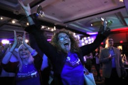 Sydney Crawford, 84, left, of New York, and JoAnn Loulan, 70, of Portola Valley, Calif., cheer as election returns come in during a Democratic party election night event at the Hyatt Regency Hotel in Washington on Tuesday, Nov. 6, 2018. (AP Photo/Jacquelyn Martin)