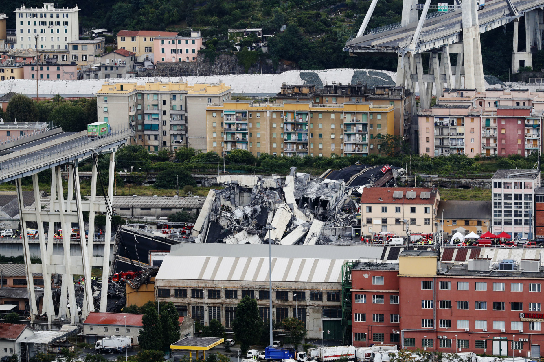 Cars are blocked on the Morandi highway bridge after a large section of it collapsed in Genoa, Italy, on Aug. 14, 2018, during a sudden and violent storm. (AP Photo/Antonio Calanni)