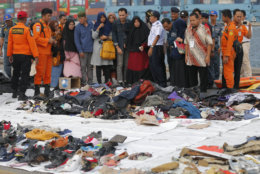 Relatives of passengers on the crashed Lion Air jet check personal belongings retrieved from the waters where the airplane is believed to have crashed, at Tanjung Priok Port in Jakarta, Indonesia, on Oct. 31, 2018. (AP Photo/Tatan Syuflana)