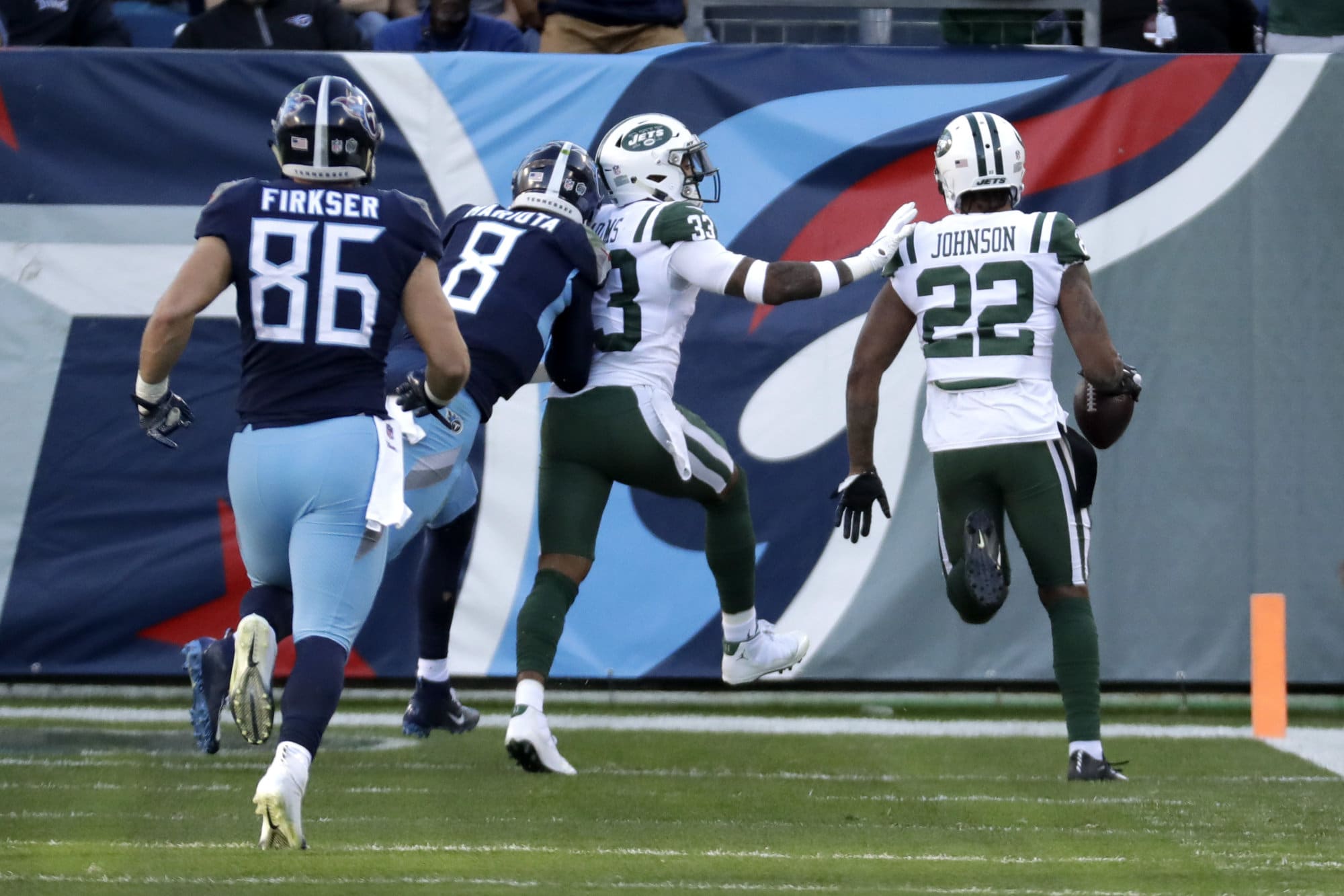 New York Jets cornerback Trumaine Johnson (22) scores a touchdown after intercepting a pass by Tennessee Titans quarterback Marcus Mariota (8) in the first half of an NFL football game Sunday, Dec. 2, 2018, in Nashville, Tenn. (AP Photo/James Kenney)