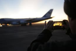 A member of the military takes a photo as the sun rises behind Special Air Mission 41, the plane that will transfer the casket of former President George H.W. Bush to Washington, Monday, Dec. 3, 2018, in Houston. Bush, died late Friday at his Houston home at age 94, is to be honored with a state funeral at National Cathedral in the nation's capital on Wednesday, followed by burial Thursday on the grounds of his presidential library at Texas A&amp;M. (AP Photo/Eric Gay)