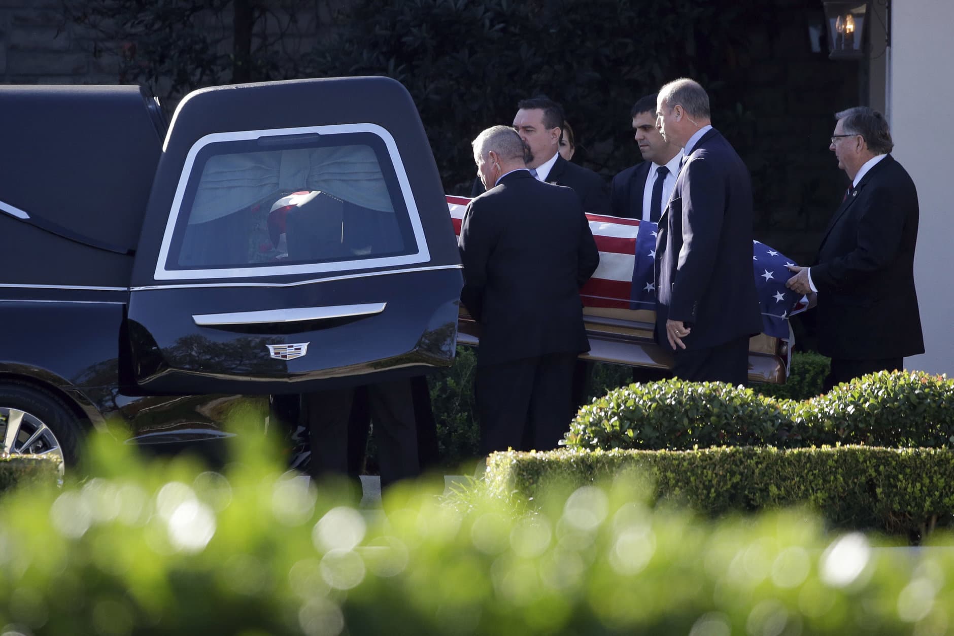 Members of the U.S. Secret Service carry the casket with former President George H. W. Bush to a hearse at George H. Lewis Funeral Home after a family service, Monday, Dec. 3, 2018, in Houston. Monday, Dec. 3, 2018, in Houston. (AP Photo/Kiichiro Sato)