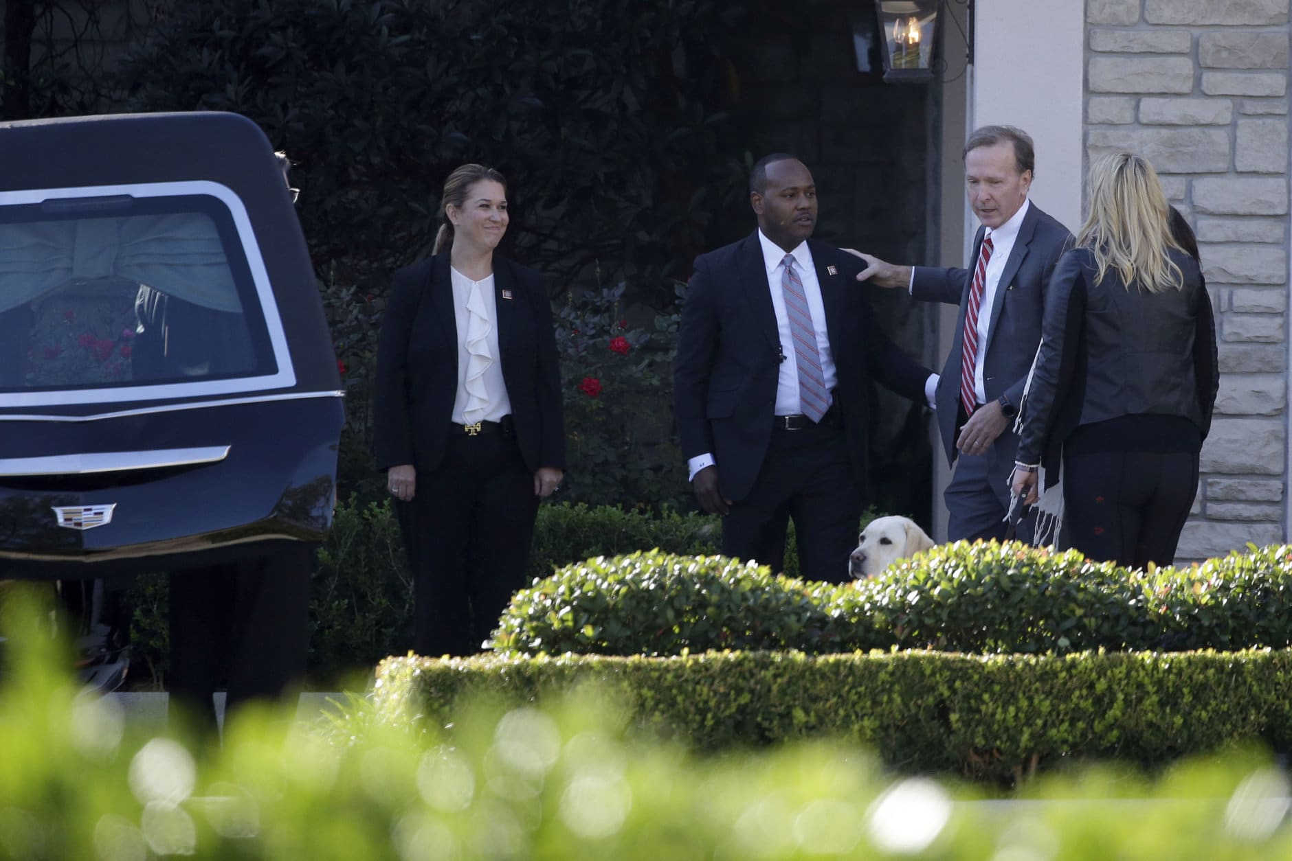 Neil Bush, right, greets members of the U.S. Secret Service after the casket of former President George H. W. Bush was placed into a hearse at the George H. Lewis Funeral Home following a family service, Monday, Dec. 3, 2018, in Houston.  (AP Photo/Kiichiro Sato)