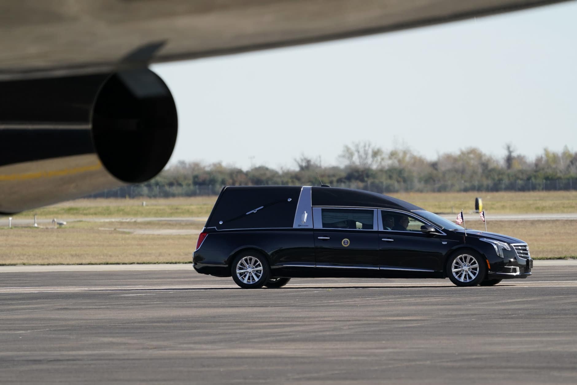 The hearse carrying the flag-draped casket of former President George H.W. Bush arrives at Ellington Field for a departure ceremony Monday, Dec. 3, 2018, in Houston. (AP Photo/David J. Phillip, Pool)