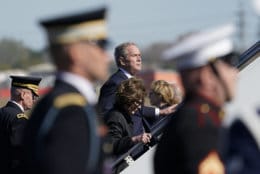 Former President George W. Bush and Laura Bush board the plane after the casket of his father, former President George H.W. Bush, was placed on the plane during a departure ceremony at Ellington Field Monday, Dec. 3, 2018, in Houston. (AP Photo/David J. Phillip, Pool)