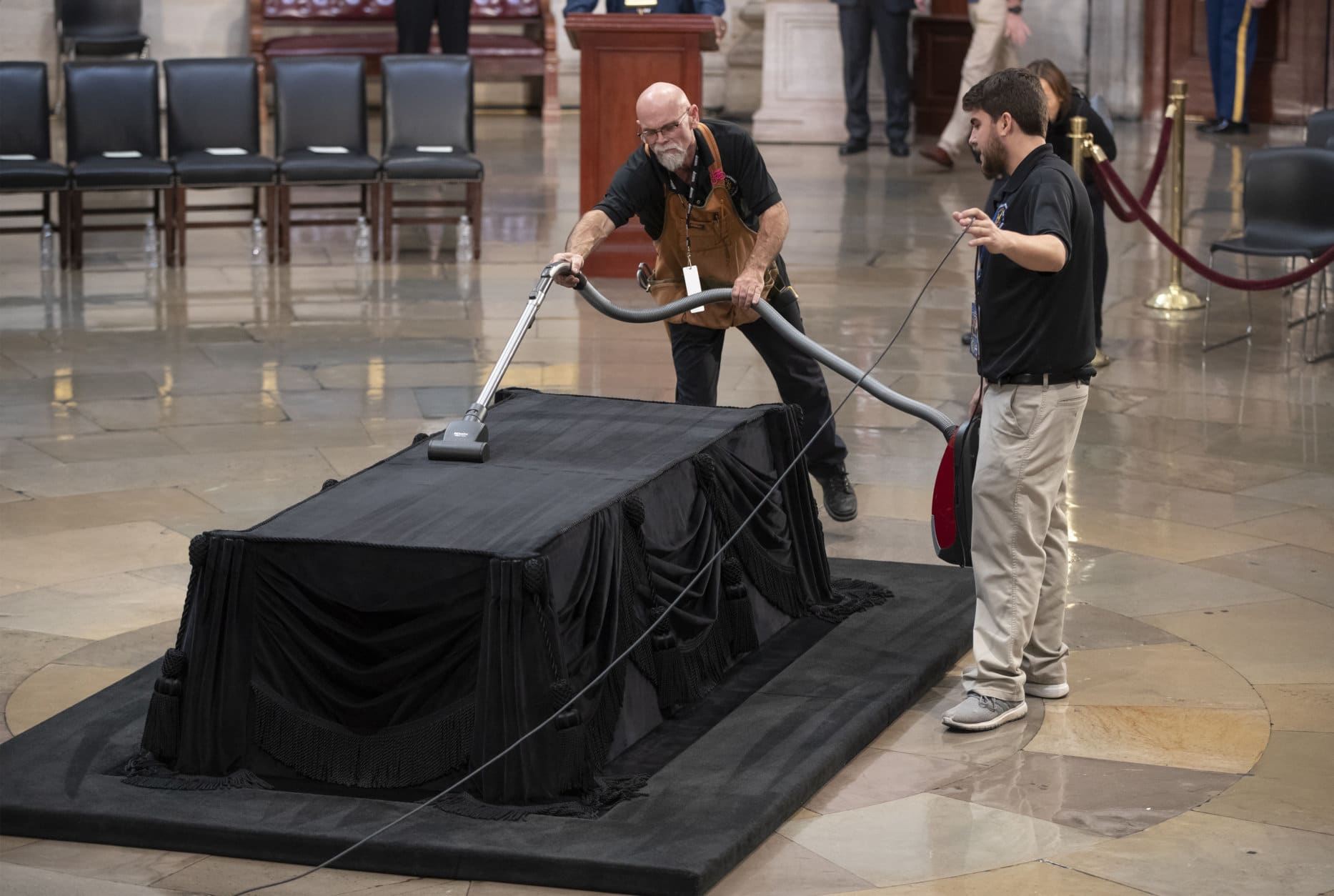 Mike Dean, lead upholsterer for the House of Representatives, and John Brady Jr., an apprentice, prepare the Lincoln Catafalque for the casket of former President George H.W. Bush, who died Friday at age 94, in the Capitol Rotunda in Washington, Monday, Dec. 3, 2018. (AP Photo/J. Scott Applewhite)