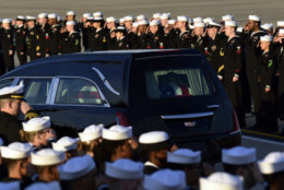 Sailors from the USS George HW Bush, the newsiest aircraft carrier in the fleet, pay their respects as the flag-draped casket of former President George H.W. Bush passes by at Andrews Air Force Base in Md., Monday, Dec. 3, 2018. (AP Photo/Susan Walsh)