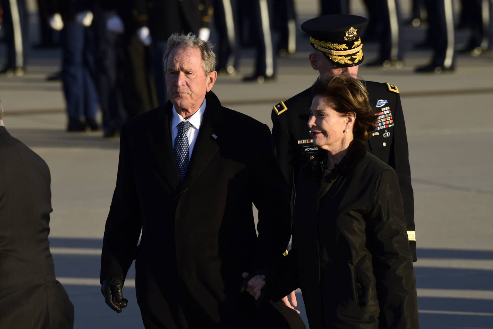 Former President George W. Bush and former first lady Laura Bush arrive at Andrews Air Force Base in Md., Monday, Dec. 3, 2018, escorting the flag-draped casket of former President George H.W. Bush. (AP Photo/Susan Walsh)