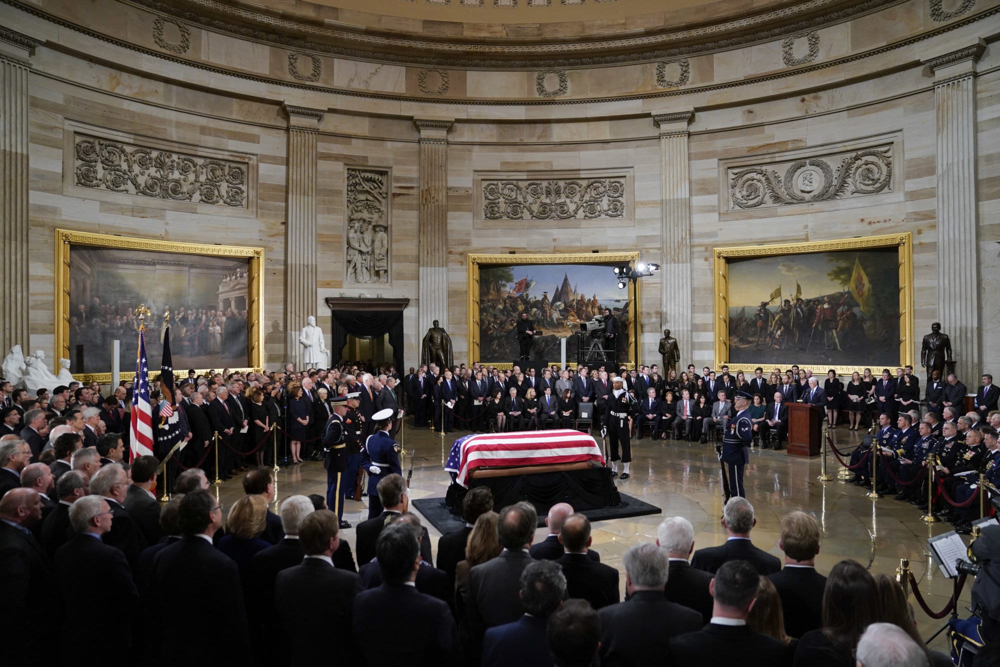 Vice President Mike Pence, right, speaks at the podium during services for former President George H.W. Bush in the Capitol Rotunda in Washington, Monday, Dec. 3, 2018. (AP Photo/Pablo Martinez Monsivais/Pool)