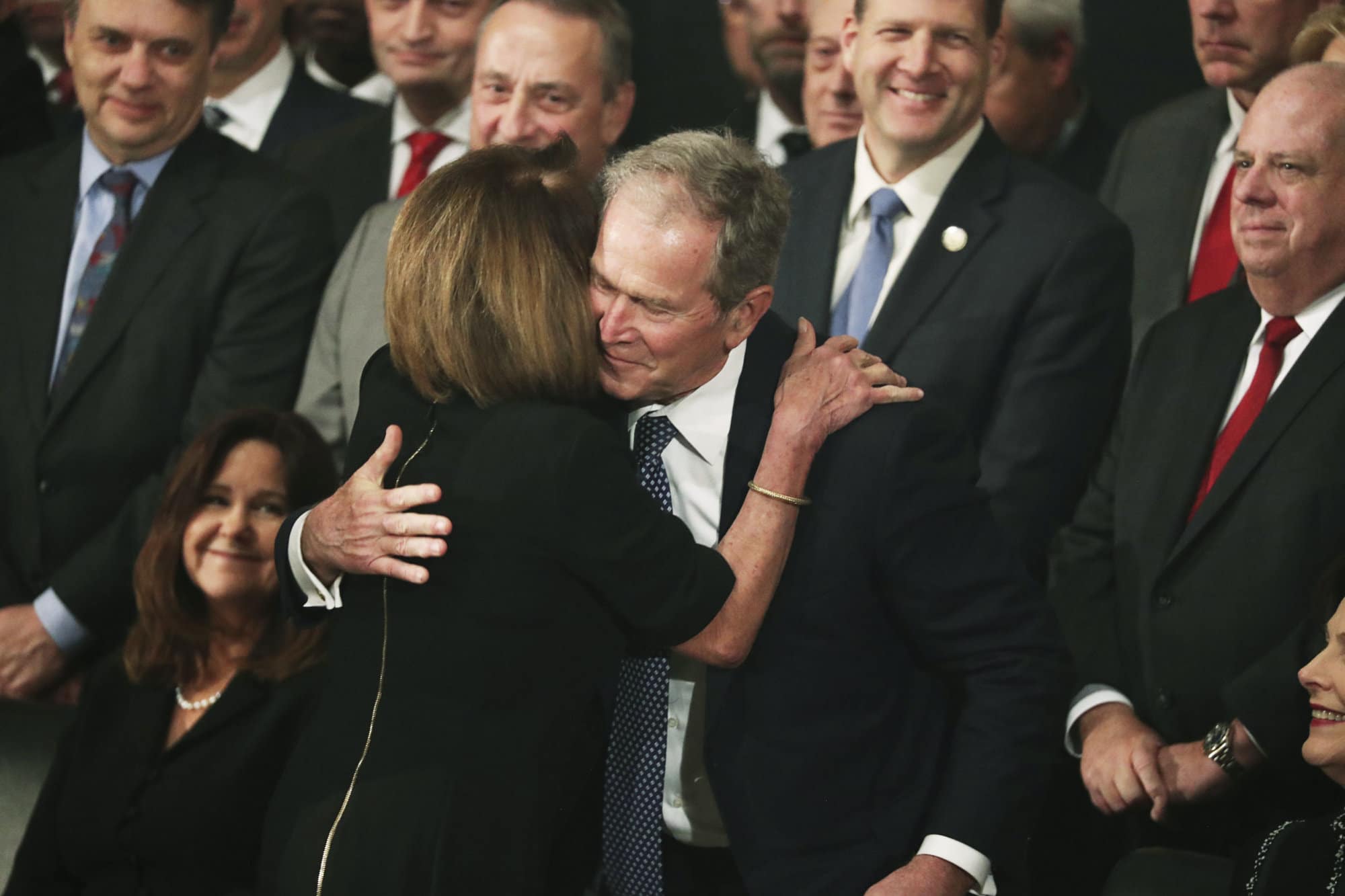 Former President George W. Bush is embraced by Democratic House Leader Nancy Pelosi, D-Calif., during the arrival of the casket of former President George H.W. Bush into the Capitol in Washington, Monday, Dec. 3, 2018. (Jonathan Ernst/Pool Photo via AP)