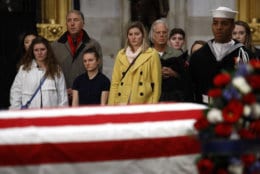 Visitors file past the flag-draped casket of former President George H.W. Bush as he lies in state in the Capitol Rotunda in Washington, Tuesday, Dec. 4, 2018. (AP Photo/Patrick Semansky)