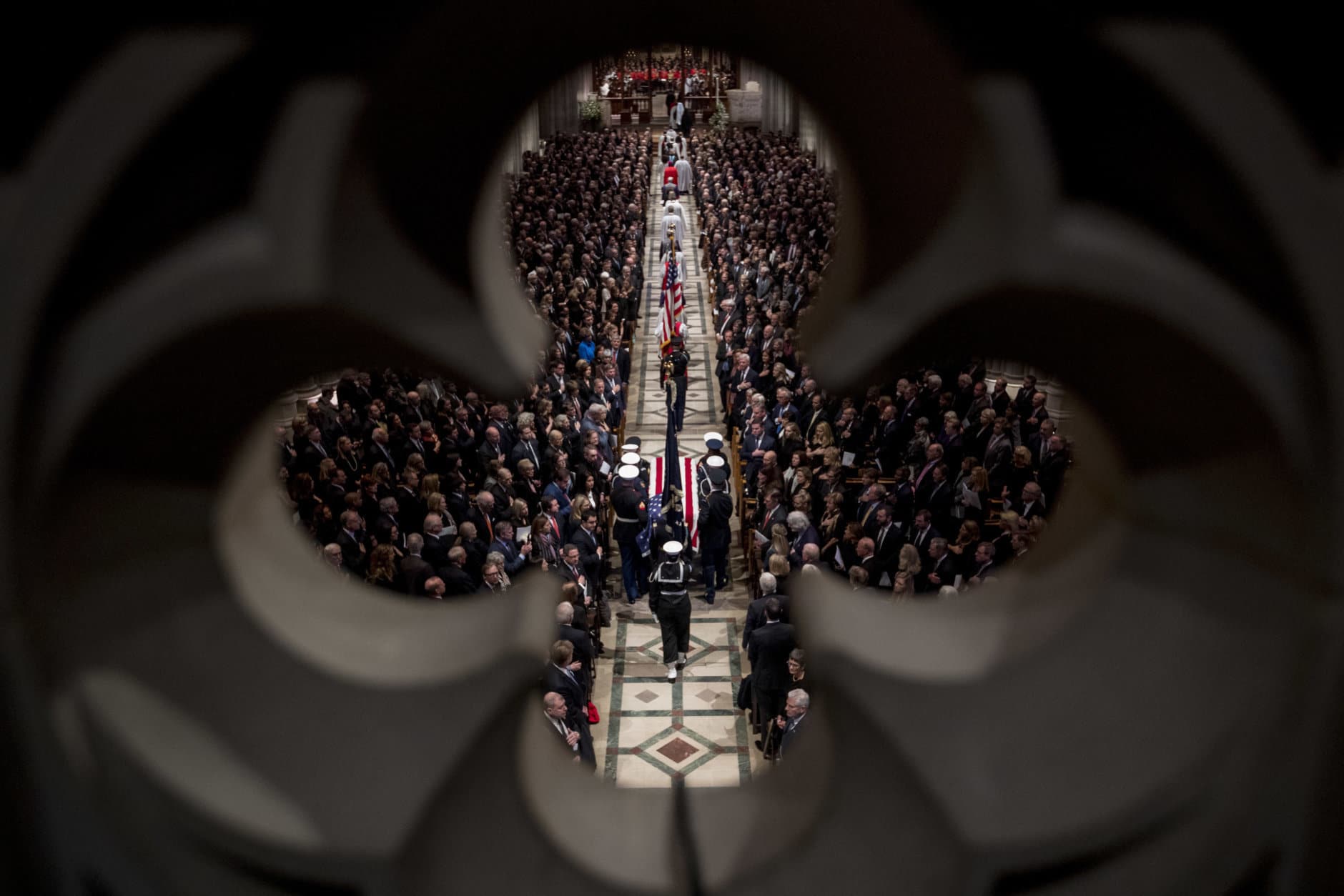 The flag-draped casket of former President George H.W. Bush is carried by a military honor guard into a State Funeral at the National Cathedral, Wednesday, Dec. 5, 2018, in Washington. (AP Photo/Andrew Harnik, Pool)