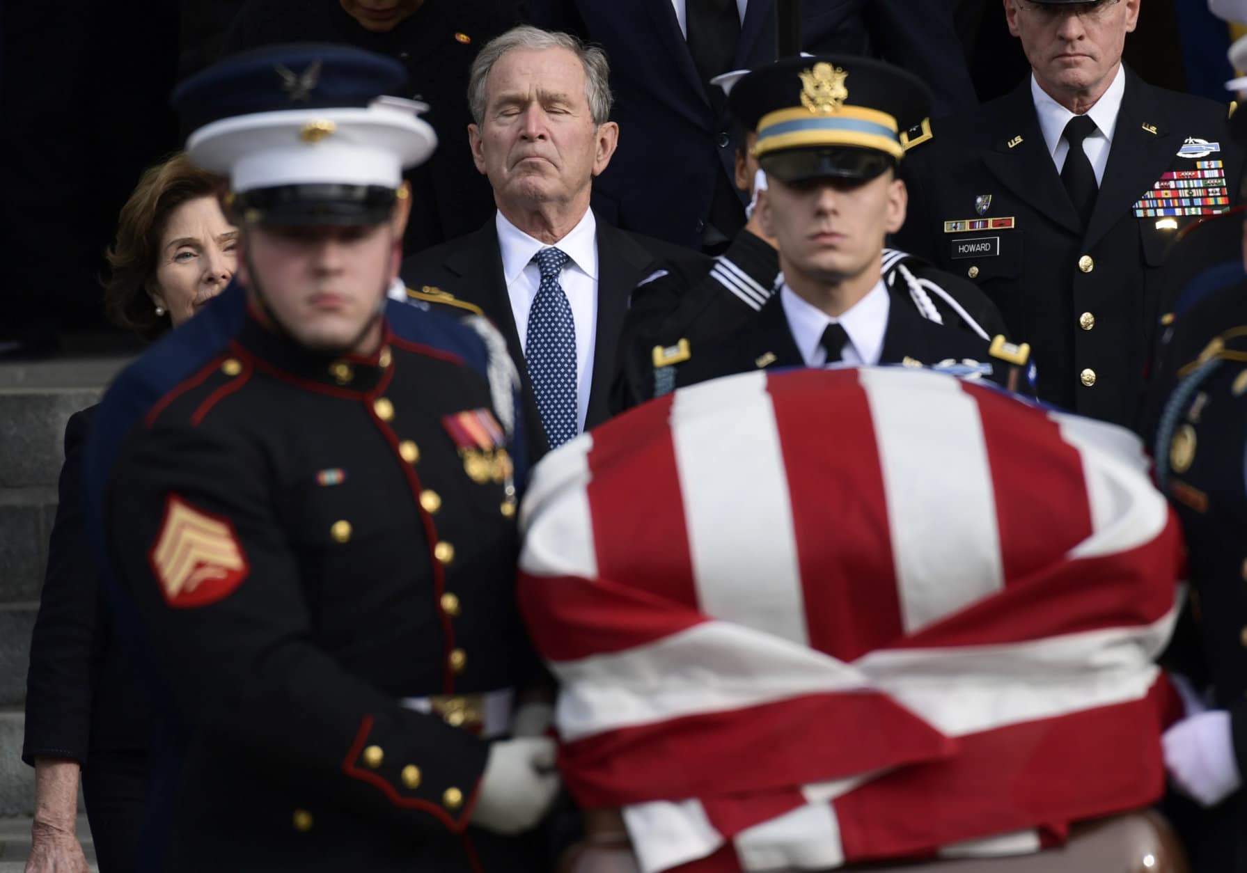 Former President George W. Bush and former first lady Laura Bush, left, follow the casket of former President George H.W. Bush as it is carried out following a State Funeral at the National Cathedral in Washington, Wednesday, Dec. 5, 2018.(AP Photo/Susan Walsh)