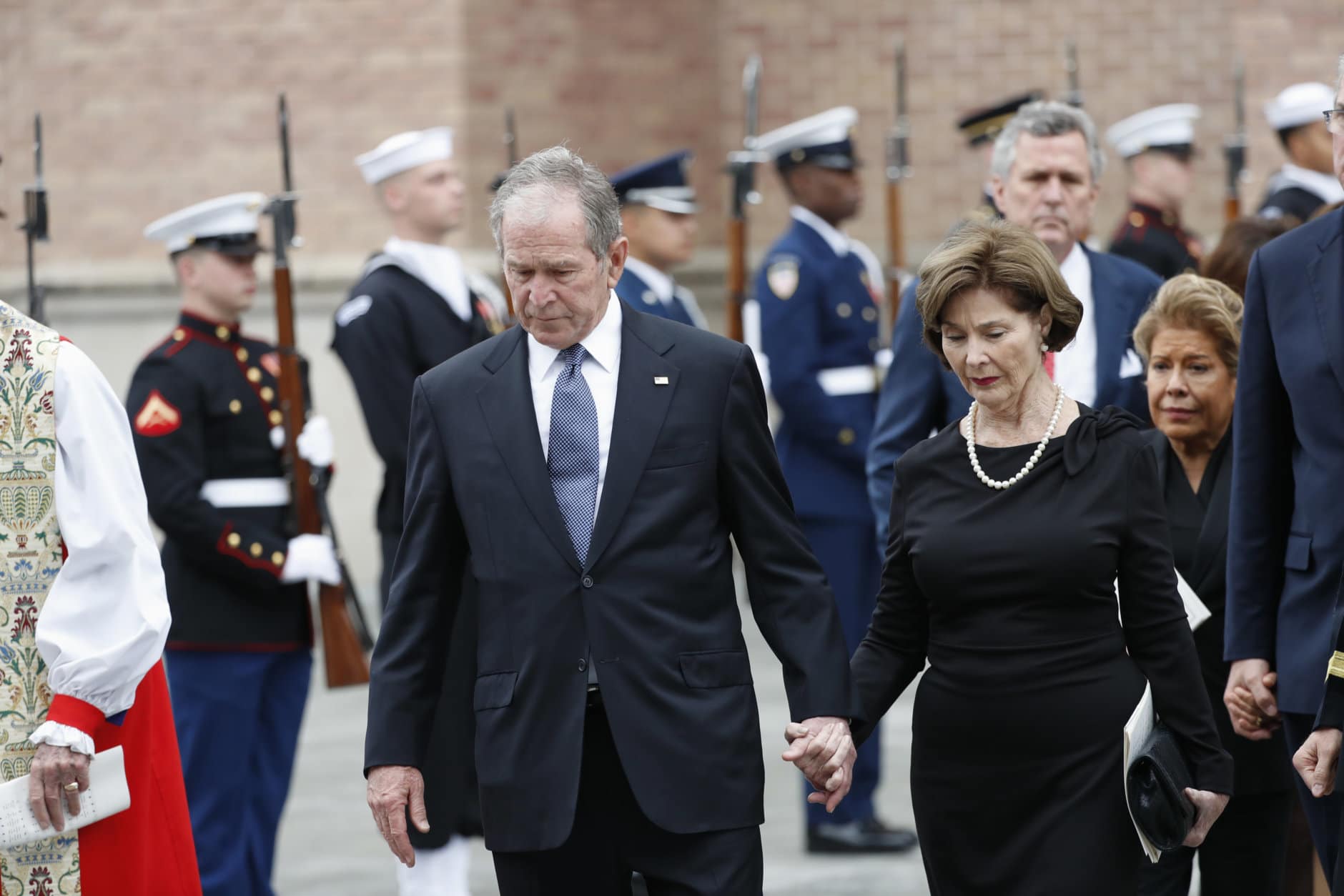 Former President George W. Bush and his wife, Laura Bush, leave St. Martin's Episcopal Church in Houston after the funeral service for his father, former President George H.W. Bush on Thursday, Dec. 6, 2018. (AP Photo/Gerald Herbert)