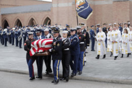 A military honor guard carries the flag-draped casket of former President George H.W. Bush from St. Martin's Episcopal Church following his funeral service Thursday, Dec. 6, 2018, in Houston. (AP Photo/Gerald Herbert)