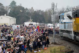 People pay their respects as the train carrying the casket of former President George H.W. Bush passes Thursday, Dec. 6, 2018, along the route from Spring to College Station, Texas. (AP Photo/David J. Phillip, Pool)