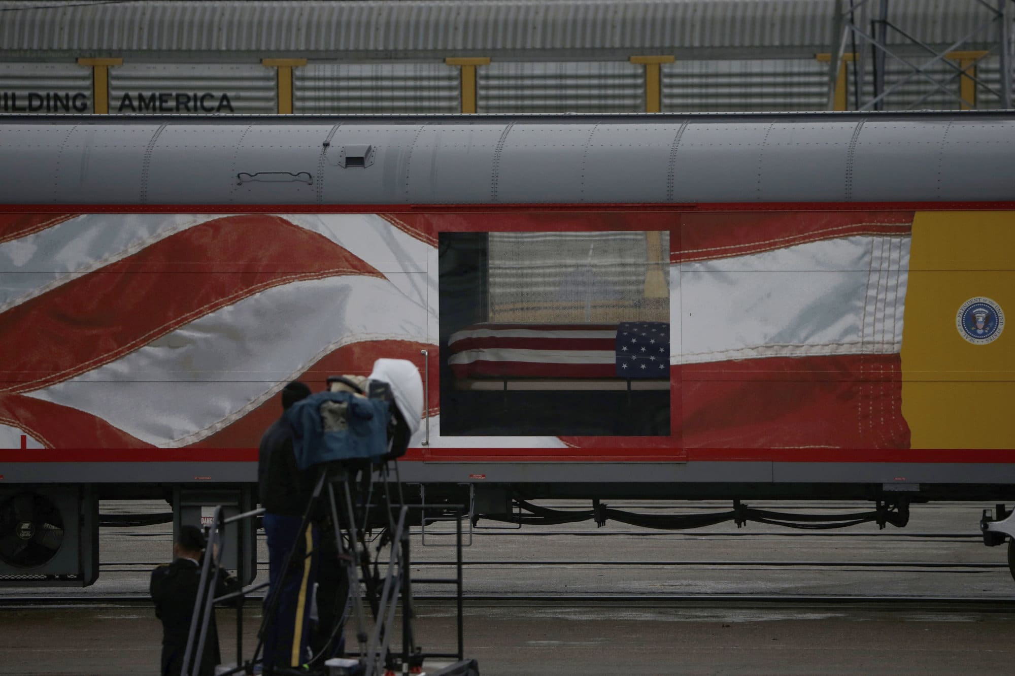 The flag-draped casket of former President George H.W. Bush leaves Union Pacific Westfield auto facility Thursday, Dec. 6, 2018, in Spring, Texas. (AP Photo/Kiichiro Sato)