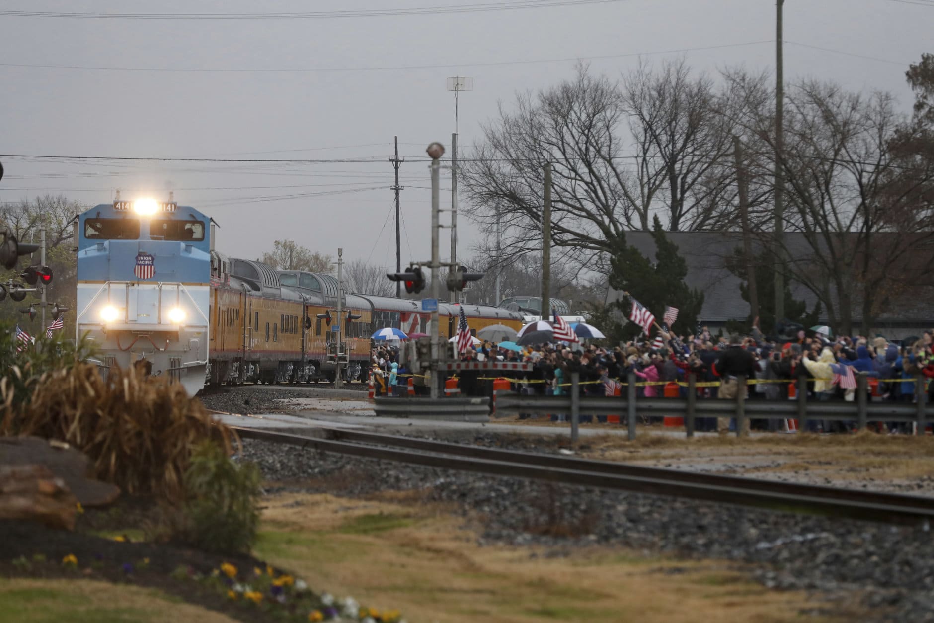 People pay their respects as the train carrying the casket of former President George H.W. Bush passes through Navasota, Texas Thursday, Dec. 6, 2018. (AP Photo/Gerald Herbert)