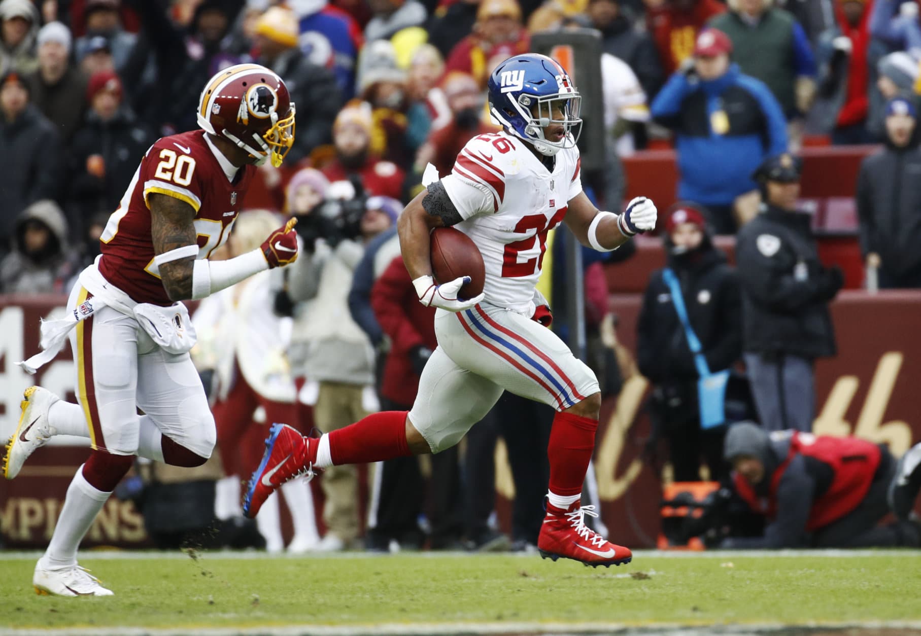 New York Giants running back Saquon Barkley (26) runs away from Washington Redskins strong safety Ha Ha Clinton-Dix (20) for a 78-yard touchdown during the first half of an NFL football game Sunday, Dec. 9, 2018, in Landover, Md. (AP Photo/Patrick Semansky)