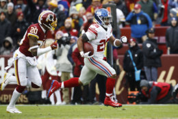 New York Giants running back Saquon Barkley (26) runs away from Washington Redskins strong safety Ha Ha Clinton-Dix (20) for a 78-yard touchdown during the first half of an NFL football game Sunday, Dec. 9, 2018, in Landover, Md. (AP Photo/Patrick Semansky)