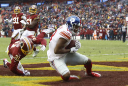 New York Giants wide receiver Bennie Fowler (18) catches a touchdown pass in front of Washington Redskins cornerback Fabian Moreau (31) during the first half of an NFL football game Sunday, Dec. 9, 2018, in Landover, Md. (AP Photo/Patrick Semansky)