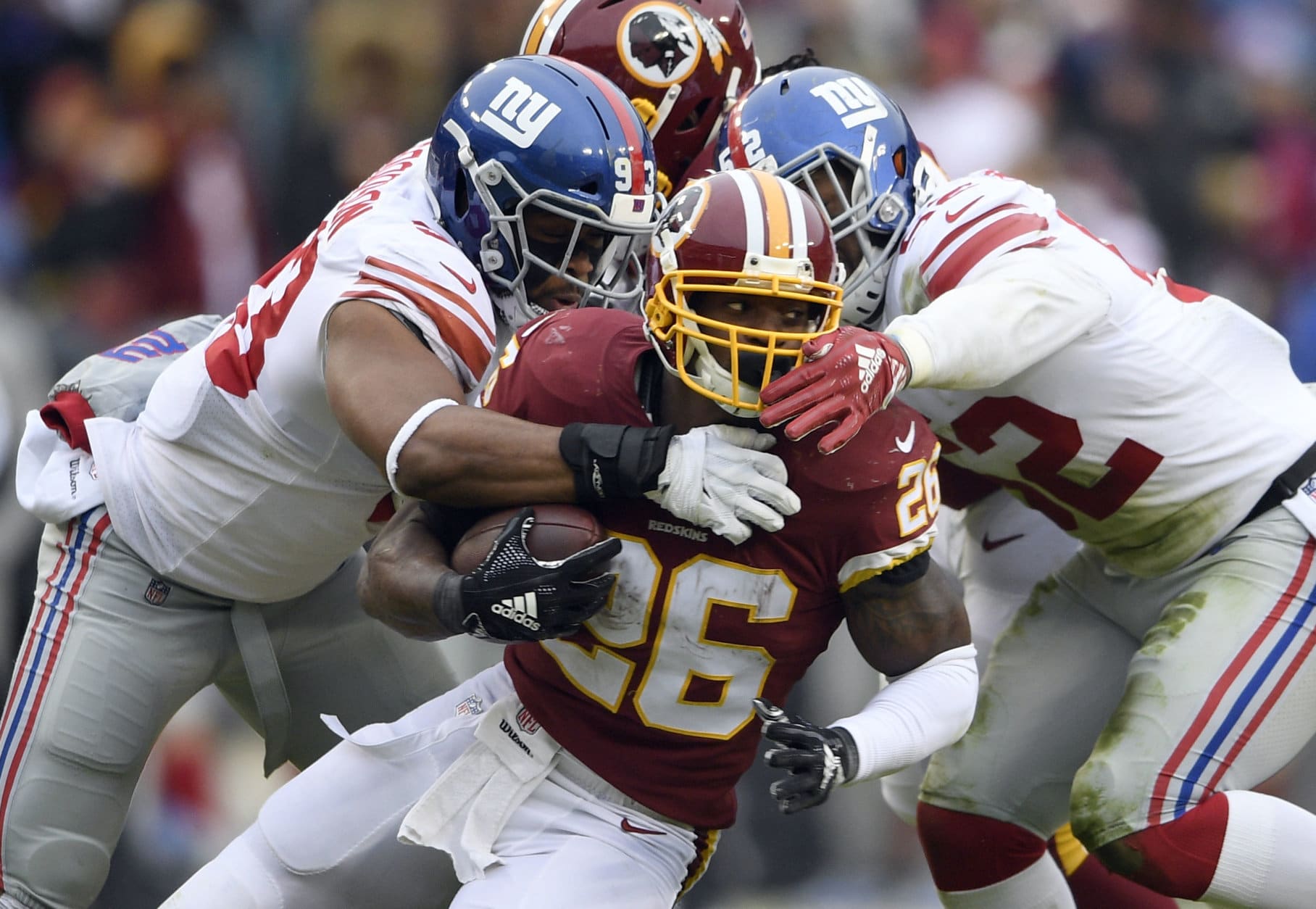 New York Giants linebackers B.J. Goodson, left, and Alec Ogletree, tackle Washington Redskins running back Adrian Peterson (26) during the first half of an NFL football game Sunday, Dec. 9, 2018, in Landover, Md. (AP Photo/Nick Wass)