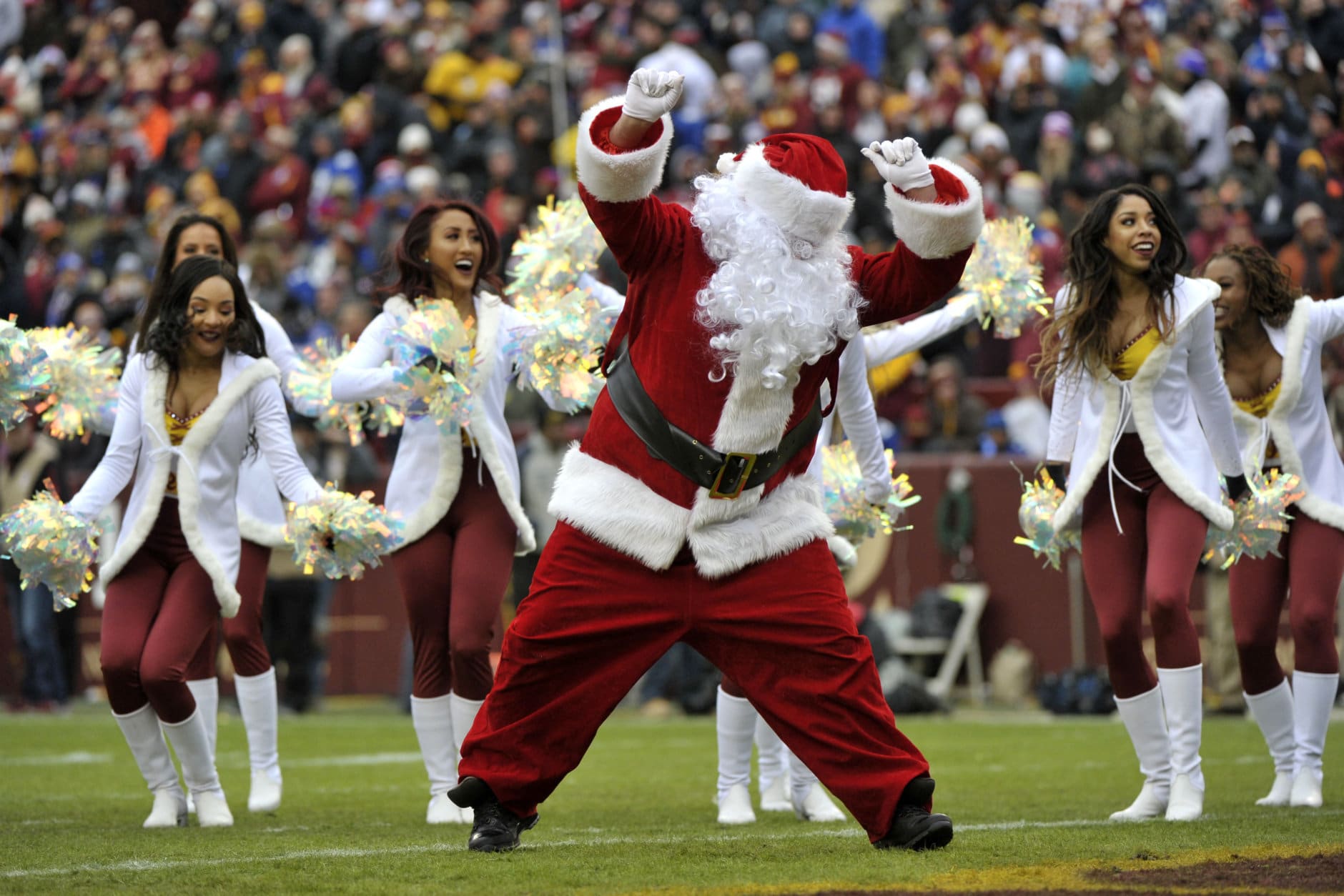 Washington Redskins cheerleaders perform with Santa Claus during an NFL football game between the New York Giants and Washington Redskins, Sunday, Dec. 9, 2018, in Landover, Md. (AP Photo/Mark Tenally)