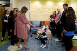 First lady Melania Trump greets children released from the neonatal intensive care unit (NICU) and their parents at Children's National Health System, Thursday, Dec. 13, 2018, in Washington. (AP Photo/Andrew Harnik)