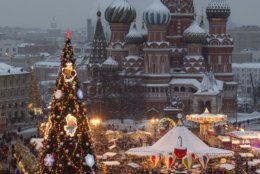Red Square decorated for New Year celebrations is seen from a roof of the Moscow GUM State Department store with a Christmas market and the St. Basil's Cathedral in the background in Moscow, Russia, Saturday, Dec. 22, 2018. (AP Photo/Alexander Zemlianichenko, Pool)